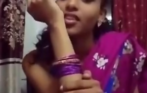 Cute girl in saree bringing about sefles.
